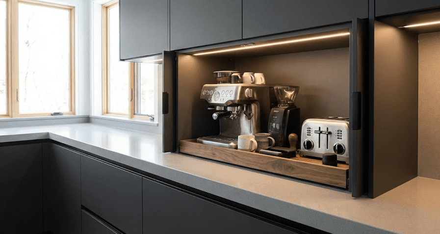 Modern Kitchen Appliance Garage A sleek modern kitchen with an open appliance garage revealing a coffee station and toaster on a pull-out tray