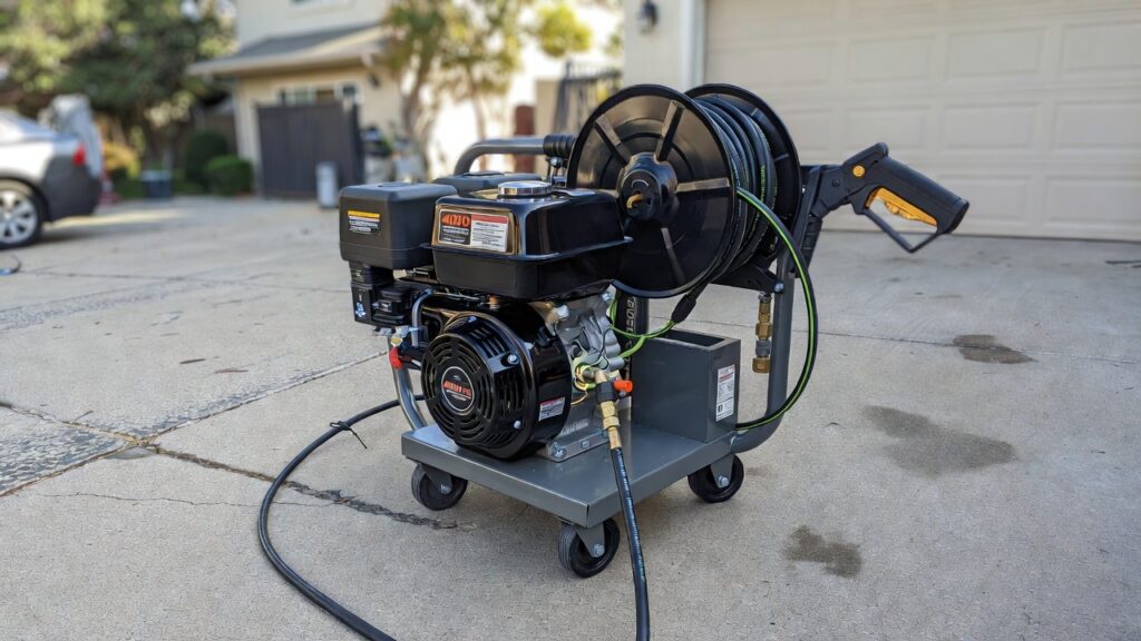 Commercial 4000 PSI Pressure Washer A heavy-duty commercial 4000 PSI gas powered pressure washer with a hose reel on a concrete driveway.