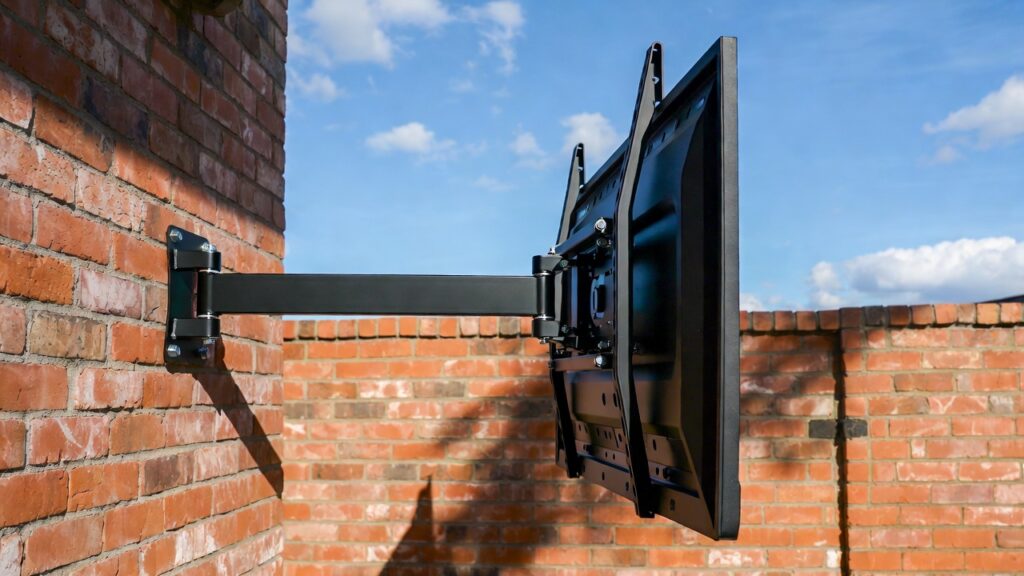 A heavy-duty, rust-proof outdoor TV mount installed safely on a brick patio wall. A heavy-duty, rust-proof outdoor TV mount installed safely on a brick patio wall.