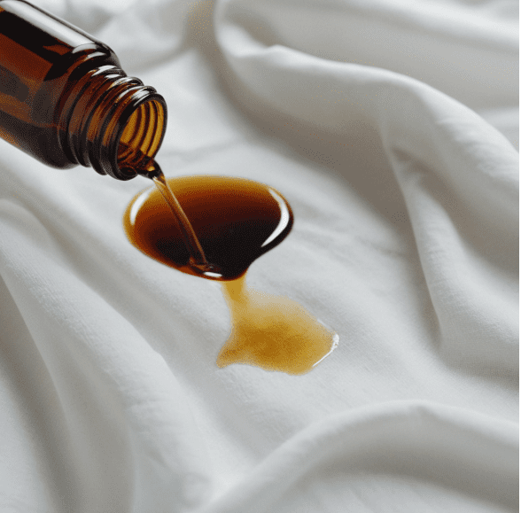 Stain on a white shirt being treated with essential oil solution
