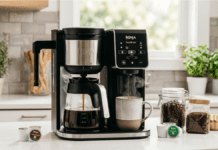 Best Dual Coffee Maker Review 2026: 5 Top 2-Way Machines A professional lifestyle photograph capturing a Ninja DualBrew Pro CM401 Dual Coffee Maker actively brewing a full carafe of coffee and a single K-Cup cup simultaneously on a modern kitchen counter