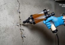 Foundation Crack Repair Cost (2026): When to DIY vs. When to Call a Pro A homeowner using a DIY injection kit to fix a foundation crack, demonstrating the cost-saving alternative to professional repair
