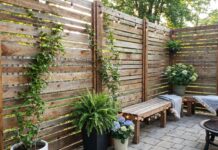 How to Build a DIY Outdoor Privacy Screen (Step-by-Step + Cheap Ideas) A DIY outdoor privacy screen built from wood slats on a backyard patio.