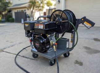 The Ultimate 4000 PSI Pressure Washer Buyer’s Guide A heavy-duty commercial 4000 PSI gas powered pressure washer with a hose reel on a concrete driveway.