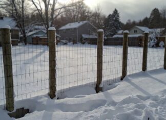 Frost Fence Cost 2026: How Much Does a Chain-Link Fence Really Cost? A newly installed frost fence with deep concrete footings in a snowy backyard.