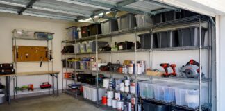 Best Heavy Duty Shelving for Garages & Warehouses (2026) A perfectly organized garage featuring a chrome heavy duty wire storage shelving unit holding tools and bins.