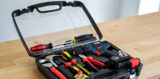 Best Tool Kit With Drill For Home (2026 DIY Starter Kits) An open, neatly organized home tool kit featuring a cordless drill on a wooden workbench ready for a DIY project.