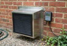 Crawl Space Exhaust Fan (2026): Stop Mold Fast A modern crawl space exhaust fan installed in a brick foundation.