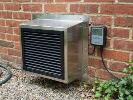 Crawl Space Exhaust Fan (2026): Stop Mold Fast A modern crawl space exhaust fan installed in a brick foundation.