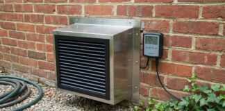 Crawl Space Exhaust Fan (2026): Stop Mold Fast A modern crawl space exhaust fan installed in a brick foundation.