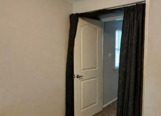 Door Soundproofing Guide 2026: Block Out Noise Fast A homeowner installing an automatic drop door sweep to block noise from entering a bedroom.