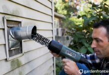 Dryer Vent Cleaning Price 2026: Actual Costs & DIY Tips A homeowner using a rotary brush tool to clean a clogged dryer vent to prevent a house fire.