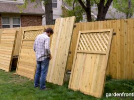 Fencing Types 2026: The Ultimate Guide to Backyard Fences A homeowner inspecting different wood fencing types in a residential backyard.