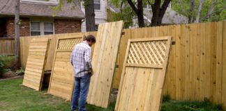 Fencing Types 2026: The Ultimate Guide to Backyard Fences A homeowner inspecting different wood fencing types in a residential backyard.