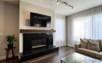 Granite Fireplaces (2026): Surrounds, Hearths & Design Ideas A modern living room featuring a sleek black granite fireplace surround and hearth.