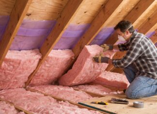 How to Insulate an Attic Roof Rafters: Best Materials & Steps (2026) Installing fiberglass insulation and ventilation baffles between attic roof rafters.