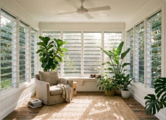 Louvered Windows (2026): Maximize Natural Airflow Modern glass louvered windows open in a bright, breezy sunroom.