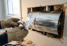 Max CFM 6 Inch Duct (2026): Fixing My 800 CFM Hood Mistake A DIY installation of an 8-inch rigid metal duct being sealed with HVAC foil tape above a powerful kitchen range hood.