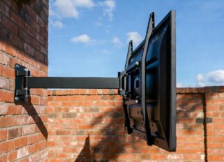 Best Outdoor TV Mounts (2026): Why Regular Mounts Rust and Fail A heavy-duty, rust-proof outdoor TV mount installed safely on a brick patio wall.