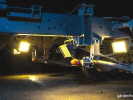 Best Magnetic Work Lights for Your Garage (2026 Reviews) A bright set of portable magnetic work lights stuck to the steel frame under a truck illuminating the suspension