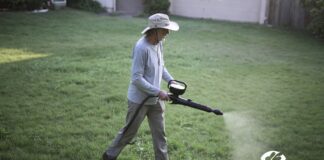 Pre-Emergent and Weed Killer: Can You Mix Them? (2026) A perfectly green, weed-free lawn next to a garden spreader applying pre-emergent and weed killer.
