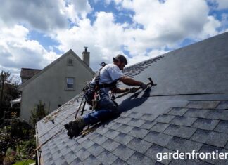 Roof Replacement Cost & Timing (2026): A $22k Mistake A professional roofer installing new architectural asphalt shingles on a residential home.