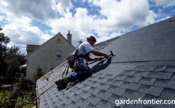 Roof Replacement Cost & Timing (2026): A $22k Mistake A professional roofer installing new architectural asphalt shingles on a residential home.