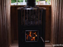 Wood Stove Sauna Heaters & Classic Wood Stoves (2026 Guide) A glowing wood stove sauna heater filled with hot stones in a cedar backyard sauna.