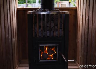 Wood Stove Sauna Heaters & Classic Wood Stoves (2026 Guide) A glowing wood stove sauna heater filled with hot stones in a cedar backyard sauna.