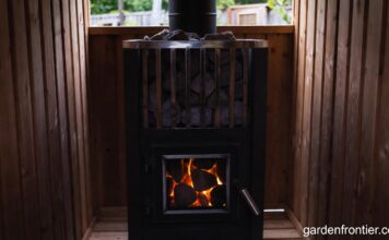 Wood Stove Sauna Heaters & Classic Wood Stoves (2026 Guide) A glowing wood stove sauna heater filled with hot stones in a cedar backyard sauna.