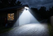 Security Flood Lights with Camera: 2026 Ultimate Guide A bright security flood light with camera illuminating a dark driveway and workshop at night