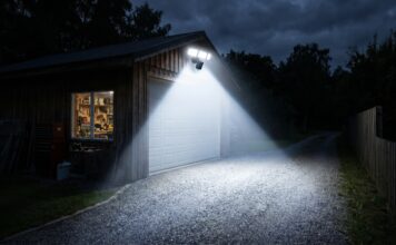 Security Flood Lights with Camera: 2026 Ultimate Guide A bright security flood light with camera illuminating a dark driveway and workshop at night