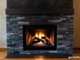 Soapstone Fireplaces (2026): Surrounds, Inserts & Maintenance A beautifully oiled dark soapstone fireplace surround radiating heat in a cozy living room