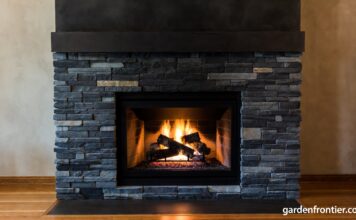 Soapstone Fireplaces (2026): Surrounds, Inserts & Maintenance A beautifully oiled dark soapstone fireplace surround radiating heat in a cozy living room