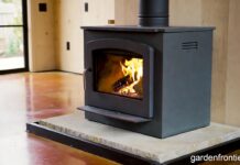Soapstone Heaters (2026): Stoves, Panels & Masonry Guide A freestanding soapstone wood stove radiating heat in a modern farmhouse living room.