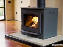Soapstone Heaters (2026): Stoves, Panels & Masonry Guide A freestanding soapstone wood stove radiating heat in a modern farmhouse living room.
