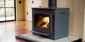 Soapstone Heaters (2026): Stoves, Panels & Masonry Guide A freestanding soapstone wood stove radiating heat in a modern farmhouse living room.