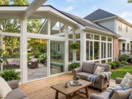 Sunroom Addition Cost (2026): Complete Expert Breakdown & Real Examples A beautiful, newly built 4-season sunroom addition attached to a suburban home with large glass windows