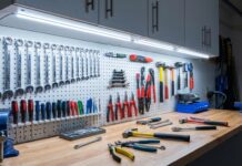 Best Under Cabinet Lighting for Workshops & Garages A bright workbench illuminated by cool under cabinet lighting showing tools clearly without shadows.