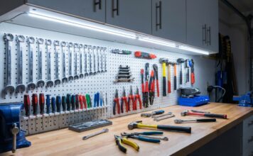 Best Under Cabinet Lighting for Workshops & Garages A bright workbench illuminated by cool under cabinet lighting showing tools clearly without shadows.