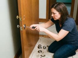 How to Change a Doorknob: Easy Replacement Steps, Fit Checks & Fixes Homeowner installing a new interior doorknob with a screwdriver on a white door