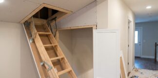 Attic Door Installation: Cost, Steps & When to Hire a Pro A contractor installing a ceiling attic access door with a framed opening and pull-down attic ladder