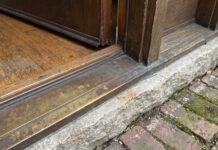 Door Sill Plate Guide: Exterior Door Replacement, Types, Leaks & Install Tips Exterior door sill plate and threshold at the bottom of a front entry door