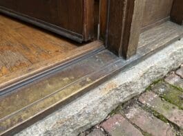 Door Sill Plate Guide: Exterior Door Replacement, Types, Leaks & Install Tips Exterior door sill plate and threshold at the bottom of a front entry door