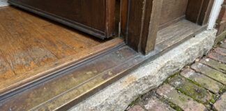 Door Sill Plate Guide: Exterior Door Replacement, Types, Leaks & Install Tips Exterior door sill plate and threshold at the bottom of a front entry door