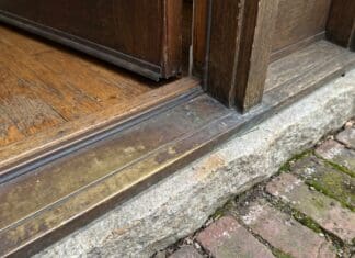 Door Sill Plate Guide: Exterior Door Replacement, Types, Leaks & Install Tips Exterior door sill plate and threshold at the bottom of a front entry door