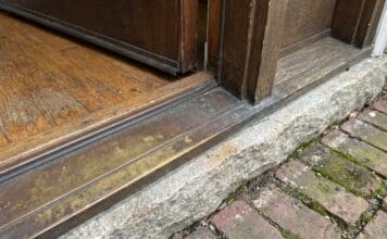 Door Sill Plate Guide: Exterior Door Replacement, Types, Leaks & Install Tips Exterior door sill plate and threshold at the bottom of a front entry door