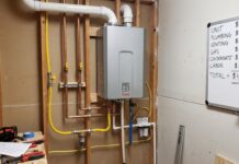 Gas Tankless Water Heater Installation Cost: Venting, Gas Lines & Sizing A gas tankless water heater installed on a utility room wall with venting and gas line connections