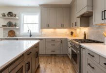 Greige Kitchen Cabinets: Best Warm Neutral Colors, Hardware & Countertops Modern kitchen with warm greige cabinets white quartz countertops black hardware and soft neutral lighting