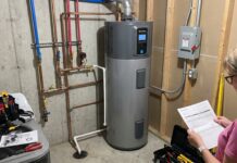 Heat Pump Water Heater Cost: Unit Price, Installation, Rebates & Hidden Expenses A hybrid heat pump water heater installed in a utility room with plumbing and electrical connections